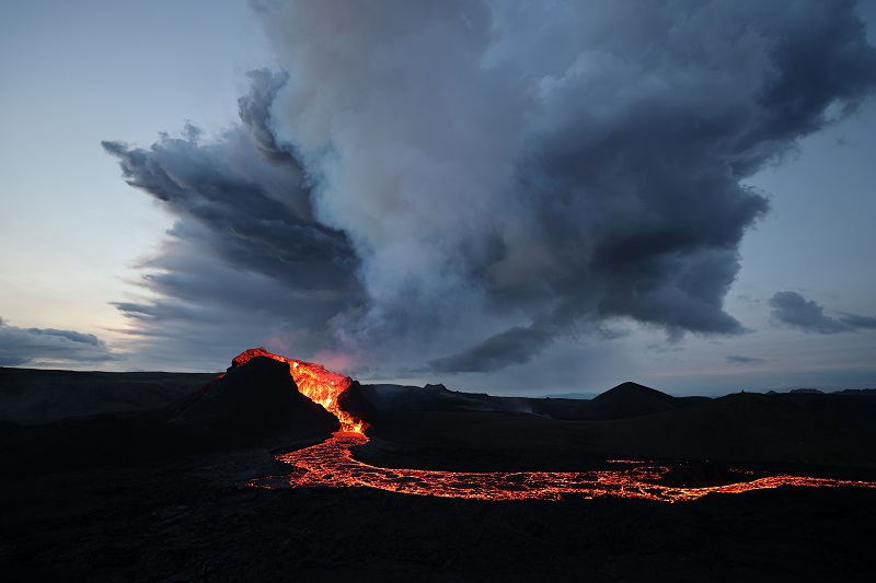 erupting volcano with flowing lava out of the crater in Iceland